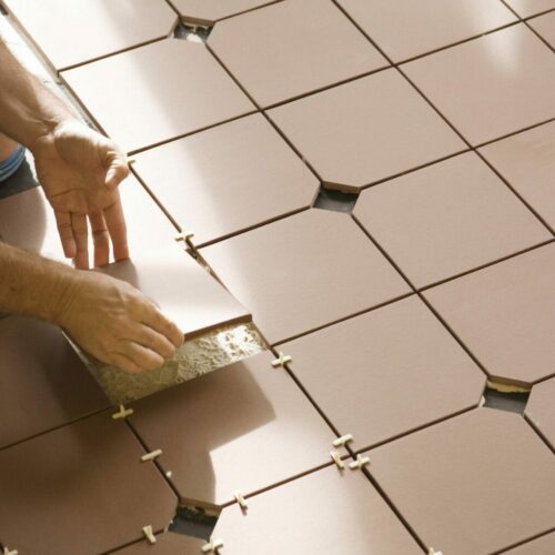 Ceramic floor tiles being installed